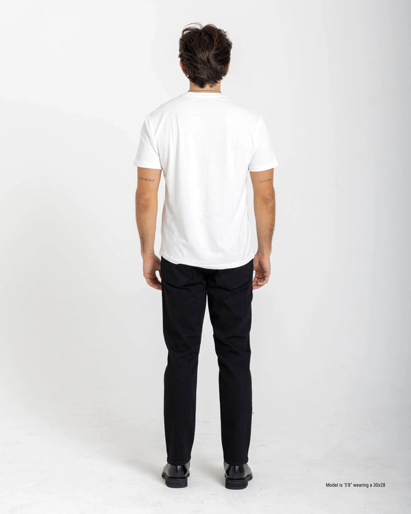Short Person wearing a white t-shirt and black jeans on a white background