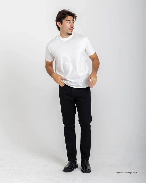 Shorter Man wearing a white t-shirt and black jeans on a white background