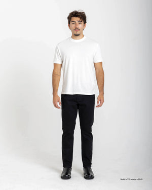 Shorter Man wearing a blue t-shirt and light blue jeans on a white background