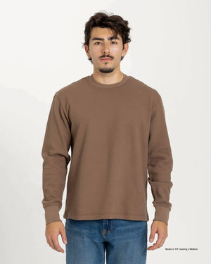 Short Man wearing a blue textured waffle shirt against a plain background