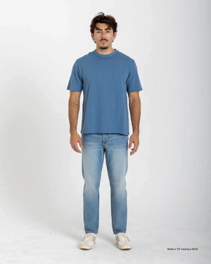 Short Man wearing a white sweater and blue jeans on a white background