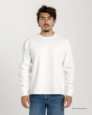 Short Man wearing a blue textured waffle shirt against a plain background